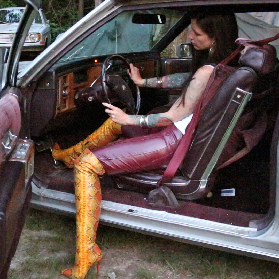 Sylvia Cranks & Revs the Cadillac in Red Leather Pants & Yellow Snake Print Boots